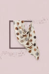 Polka dot scarf on a pink background