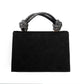 Black handbag with decorative handles on a white background