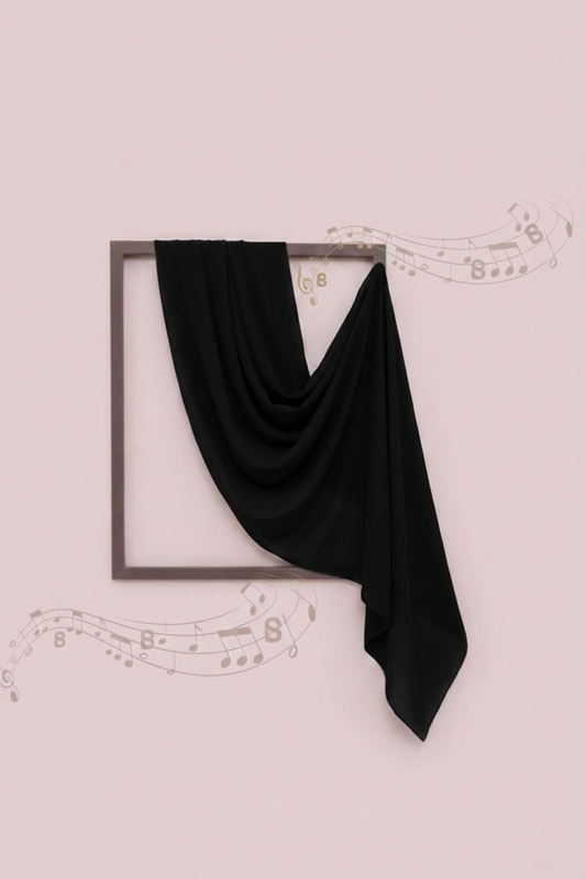 Black scarf draped over a framed picture on a light pink background