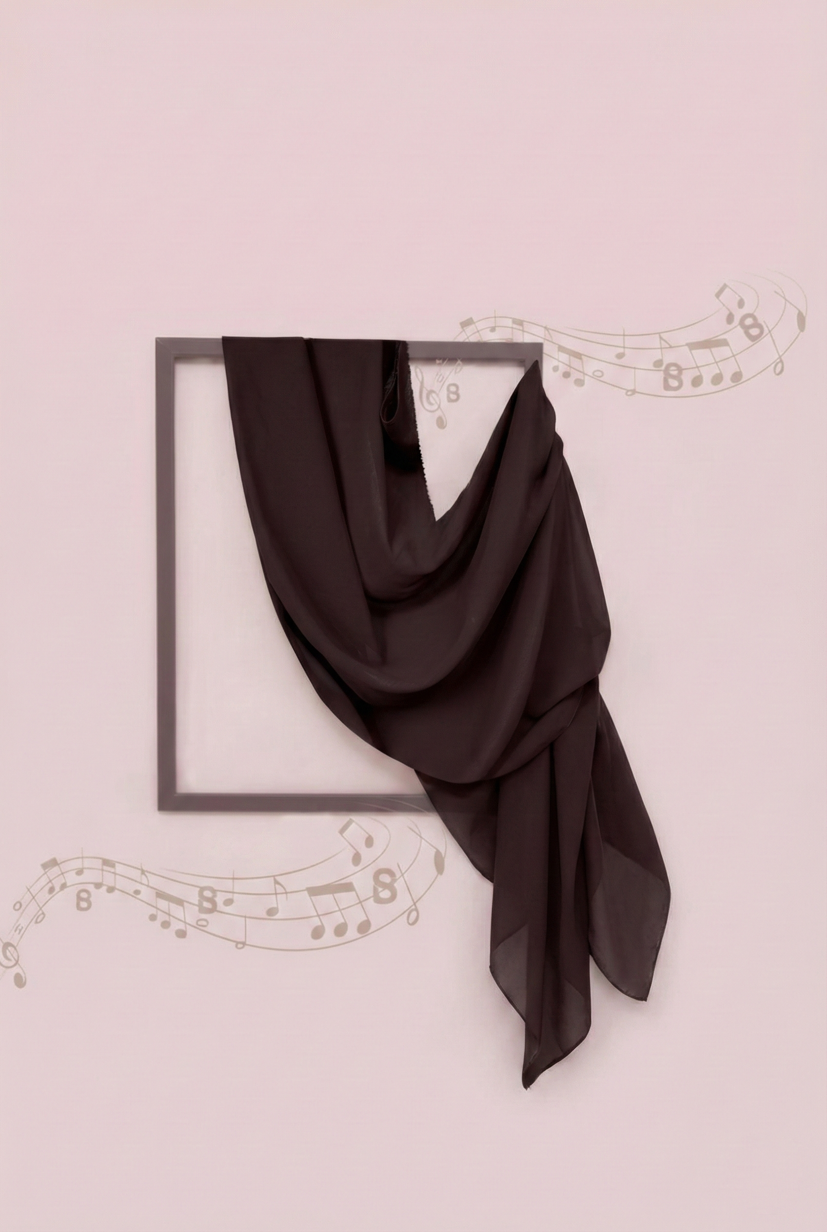 Black scarf draped over a black frame on a light pink background