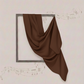 Brown fabric draped over a rectangular frame on a light background