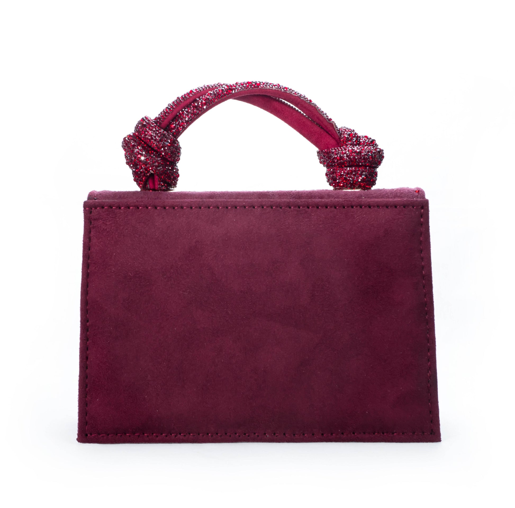Maroon handbag with decorative handle on a white background