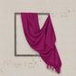 Purple scarf draped over a decorative frame on a light background