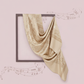 Beige scarf draped over a black frame on a pink background with musical notes.