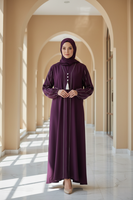 Woman in a long purple dress standing in a sunlit hallway with arches.