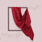 Red fabric draped over a square frame on a light pink background with musical notes.