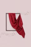 Red fabric draped over a square frame on a light pink background with musical notes.