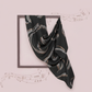 Black scarf with white patterns on a light pink background