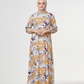 Woman wearing a floral dress with a plain background