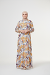 Woman wearing a floral dress with a plain background